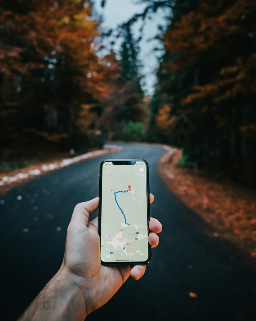 A person holding a white iPhone, representing Apple Maps and Bing Places business listings