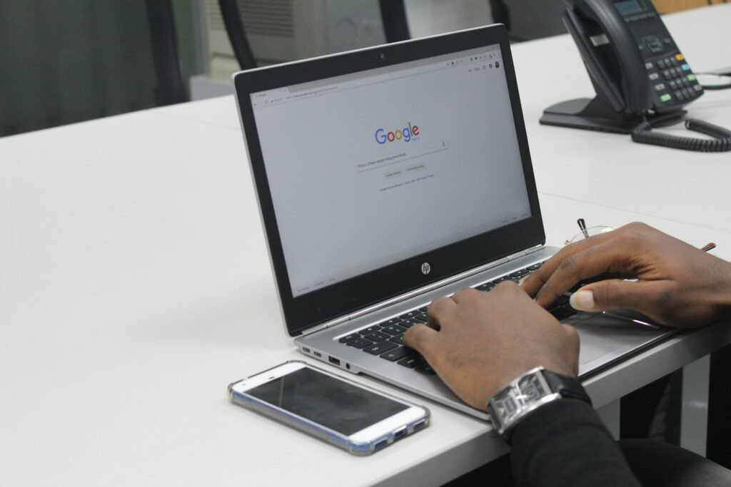 Nigerian business owner researching future of SEO and AI search strategy on laptop