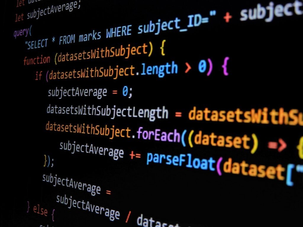 JavaScript code displayed on a laptop screen representing JavaScript for beginners