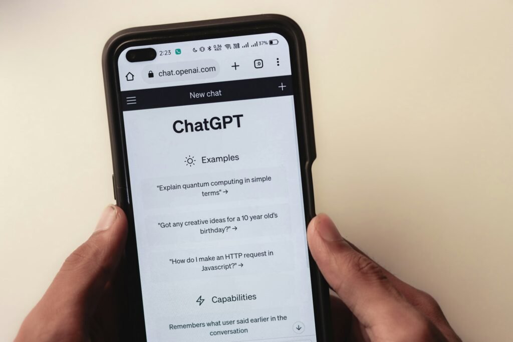 Person holding a phone showing a ChatGPT webpage, representing the map pack AI visibility gap