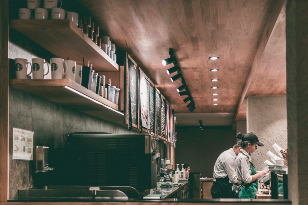 A barista working in a coffee shop, representing multi-location businesses managing SEO across branches