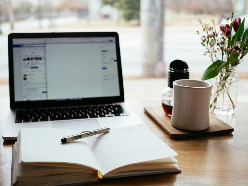 Laptop and notepad on a desk, representing building a blog with Next.js and a headless CMS