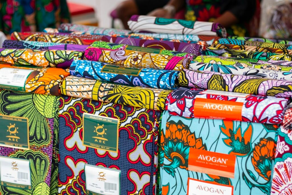Colorful Nigerian fabrics displayed for sale, representing fashion brands exporting to the US market