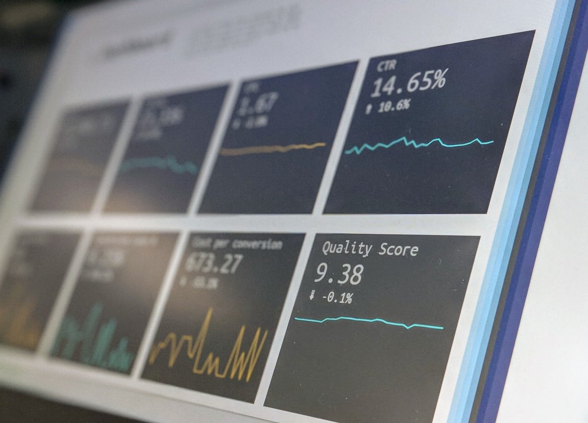 Laptop computer displaying website analytics on a glass-top table