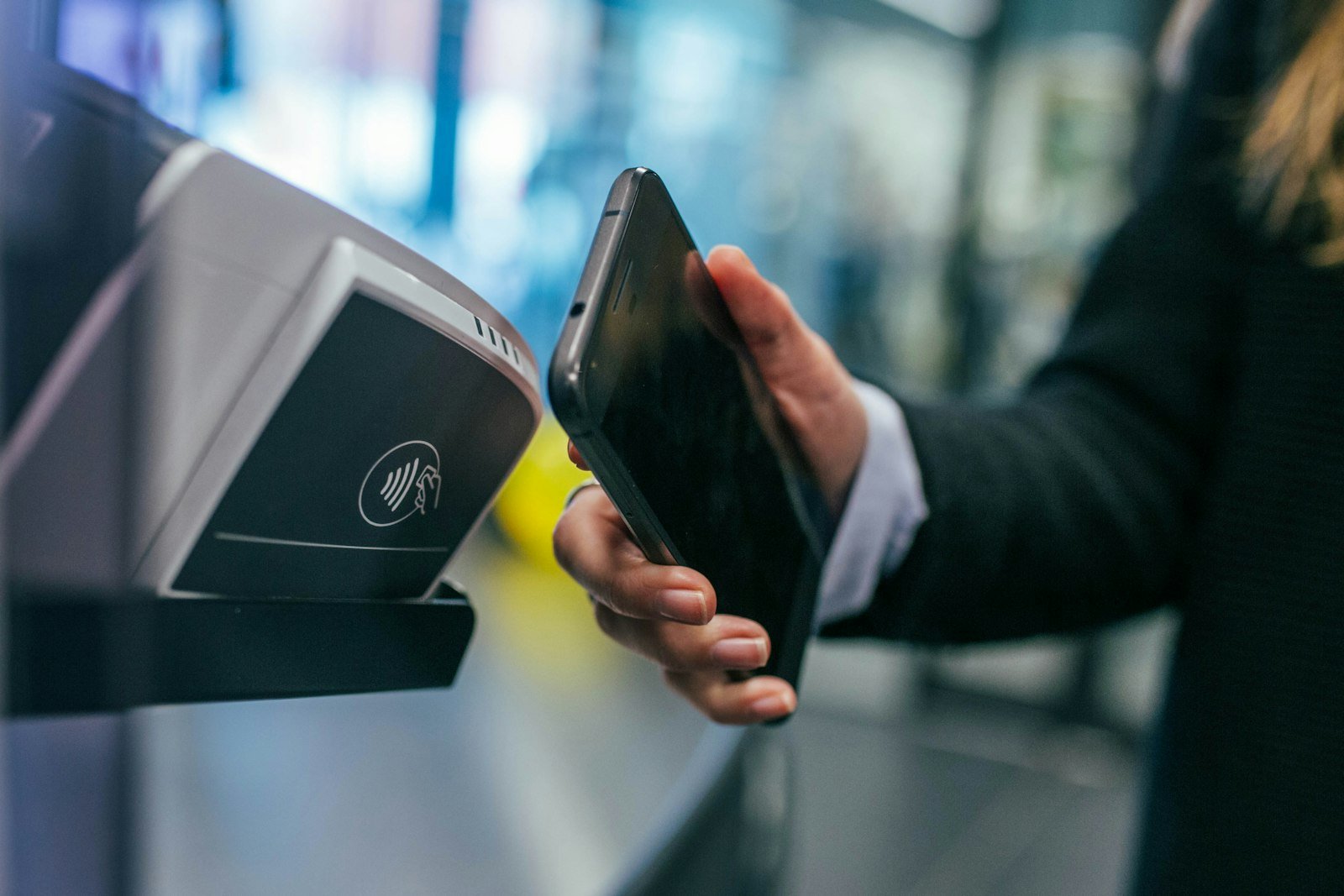 Person holding a smartphone representing mobile money transfer app search
