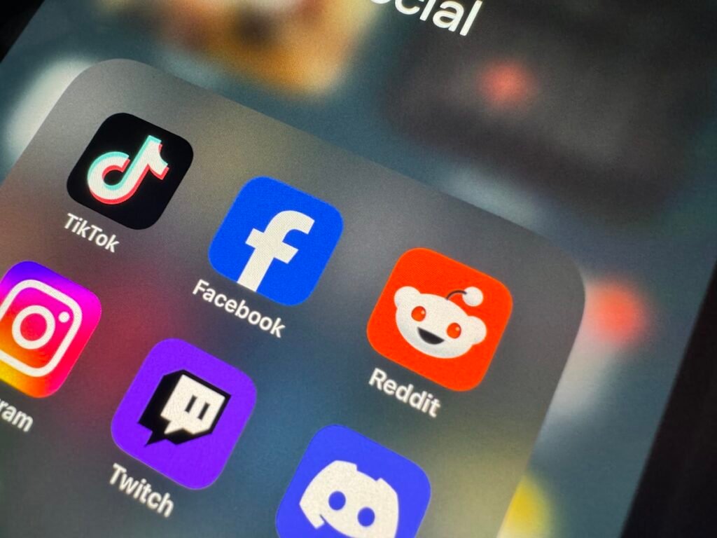 Close up of a phone screen showing Reddit and other social app icons