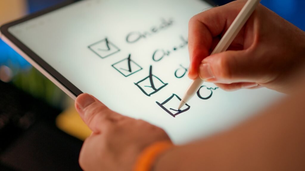 A hand marking off items on a checklist, representing testing React components step by step