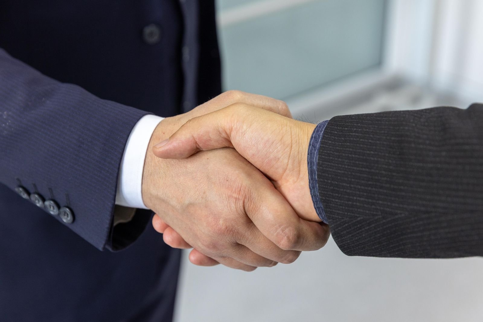 Professional handshake symbolizing trust between a Nigeria-based agency and a US client