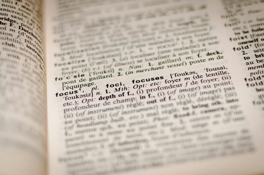 Open dictionary page representing US and Nigerian English spelling differences