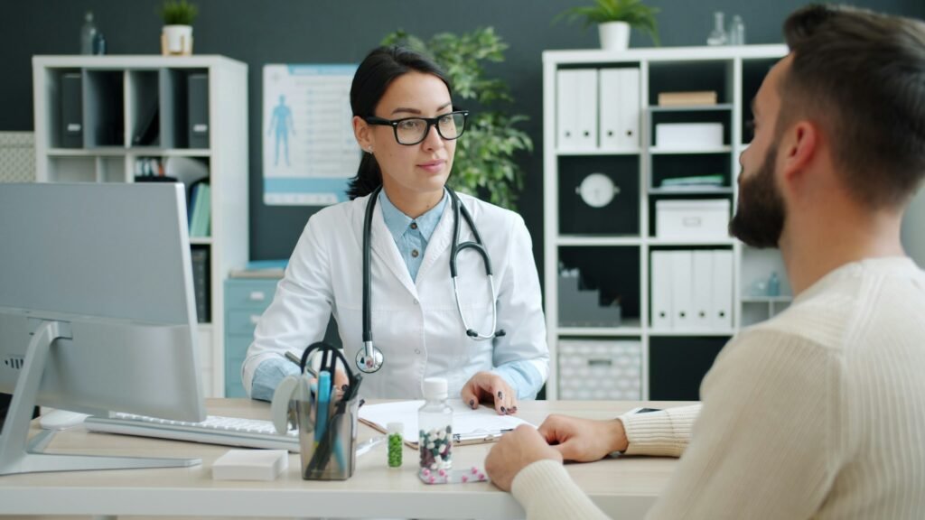 Doctor consulting with a patient in a medical office, representing YMYL healthcare SEO