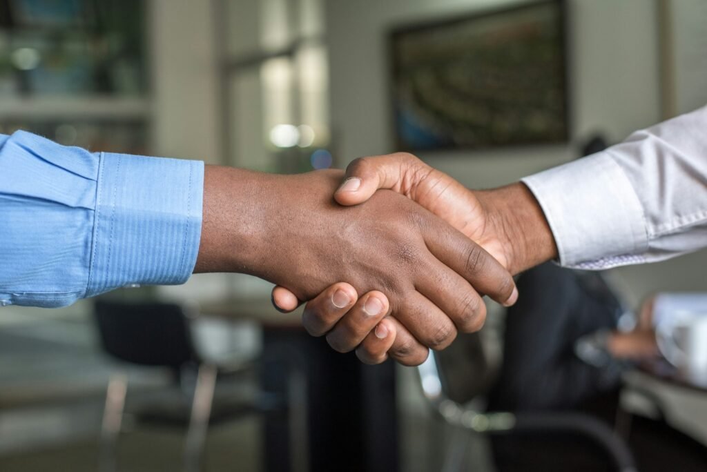 Two people shaking hands after a business agreement, representing how to choose the right SEO agency in Nigeria