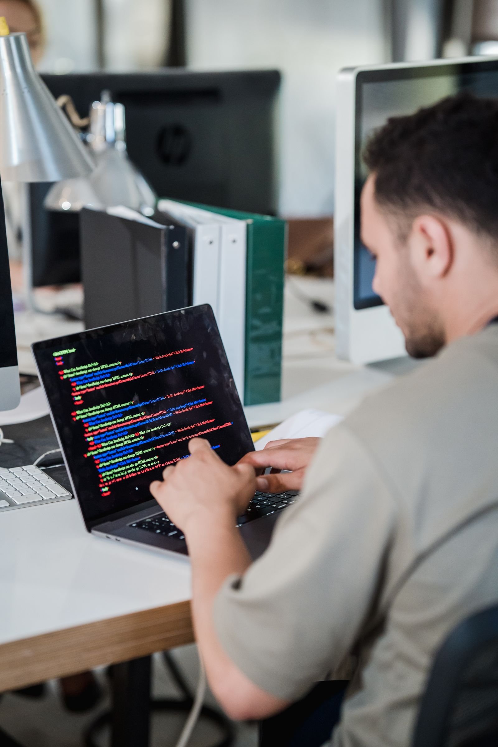 Developer writing code on a laptop while building a custom WordPress plugin