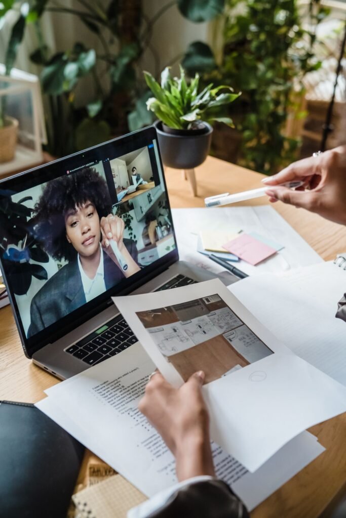 Businesswoman on a remote video call reviewing documents, representing a remote SEO consultant discovery call