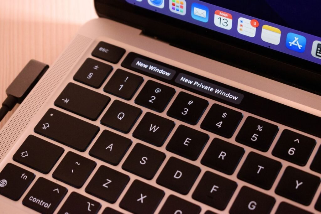 Close-up of a laptop keyboard with browser tabs open, representing WebMCP site tools in ChatGPT's desktop browser