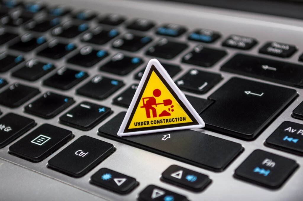 A small warning sign placed on a laptop keyboard, representing a Google manual action or penalty warning