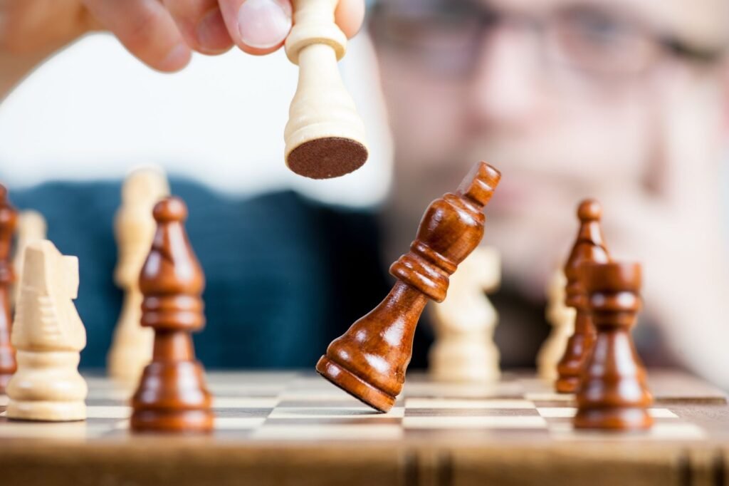 Man holding a chess piece representing SEO competitive strategy