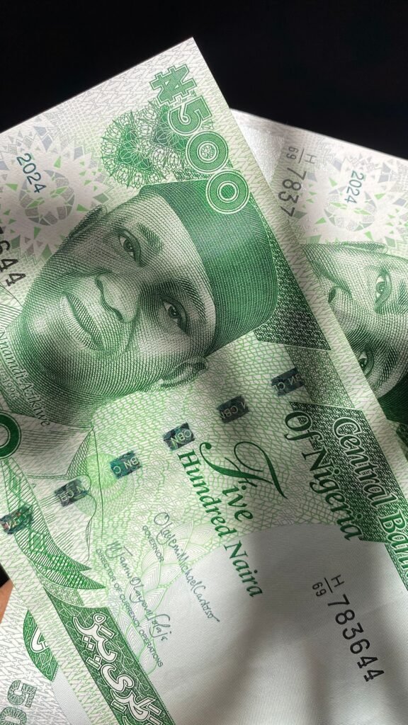 Close-up of Nigerian five hundred naira notes, representing the cost comparison between in-house and outsourced SEO