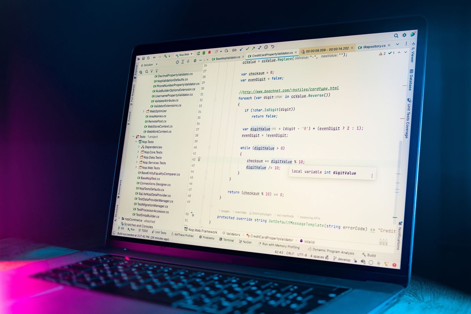 Laptop displaying a code editor with JavaScript and PHP syntax used in WordPress plugin development