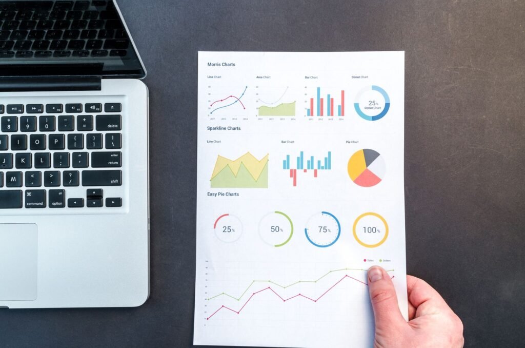 Hand holding printed charts and graphs showing a ranking drop, representing a Google core update analysis