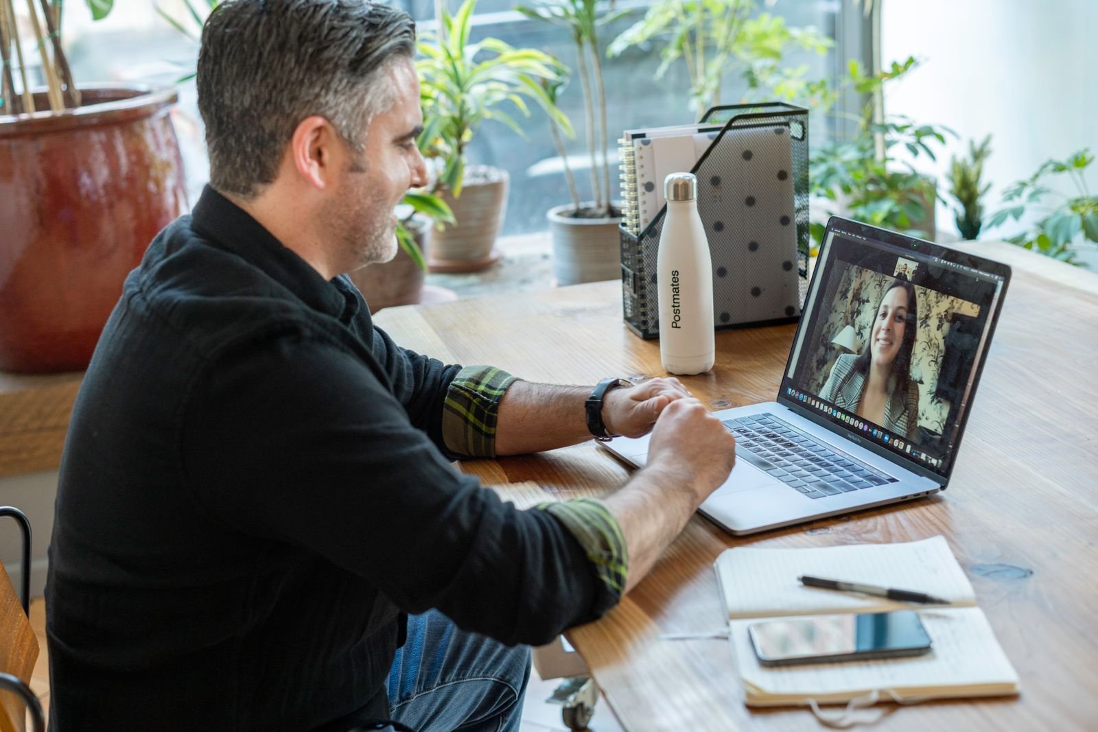 Man on a video call from a home workspace, representing a remote SEO consultant vetting call