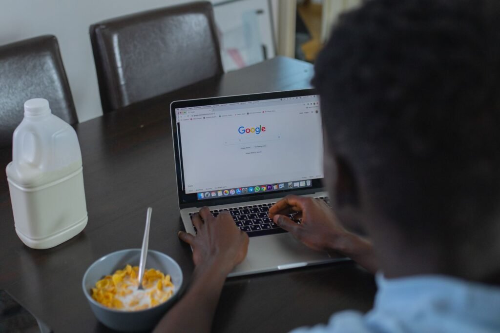 Person browsing Google search results on a laptop
